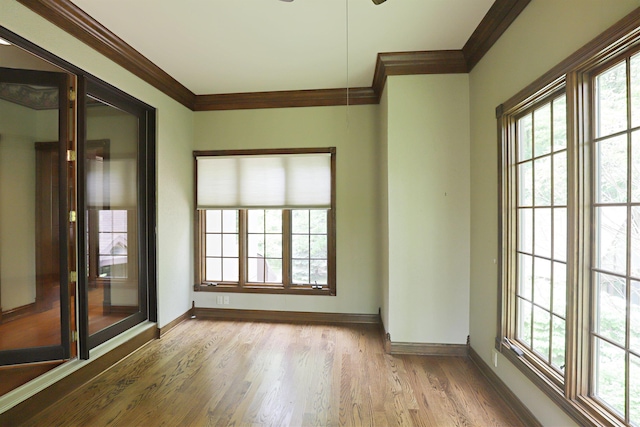 10466 W Farrand Rd, Montrose, MI 48457 - empty room featuring ornamental molding, healthy amount of natural light, wood finished floors, baseboards, and a ceiling fan
