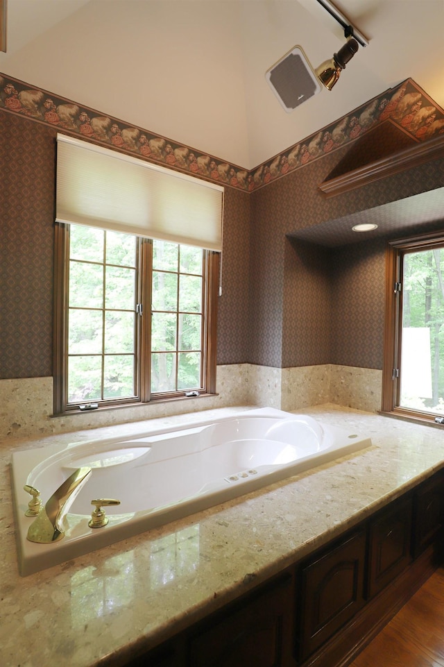 10466 W Farrand Rd, Montrose, MI 48457 - full bath featuring wallpapered walls, healthy amount of natural light, a bath, and wood finished floors