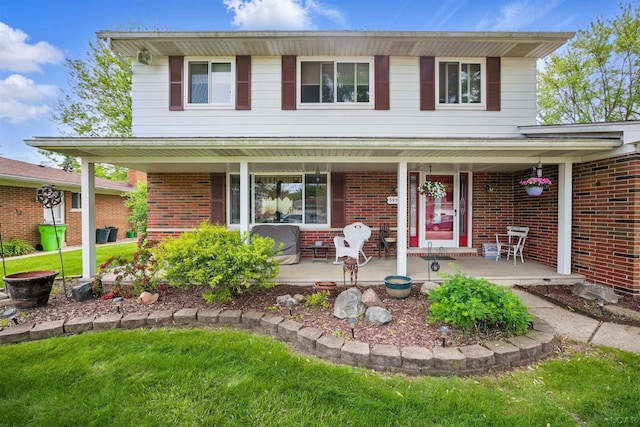 39582 Tunstall St, Clinton Township, MI 48038 - traditional home featuring a porch, brick siding, and a front yard