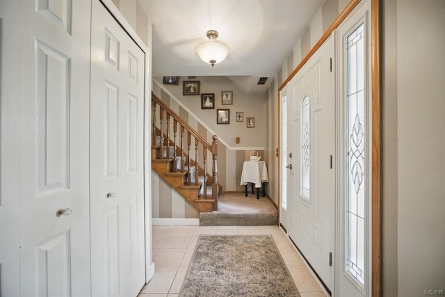 39582 Tunstall St, Clinton Township, MI 48038 - foyer entrance featuring light tile patterned floors, stairs, and baseboards
