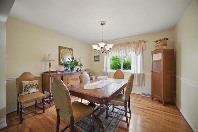 39582 Tunstall St, Clinton Township, MI 48038 - dining area with a chandelier, light wood-type flooring, and baseboards