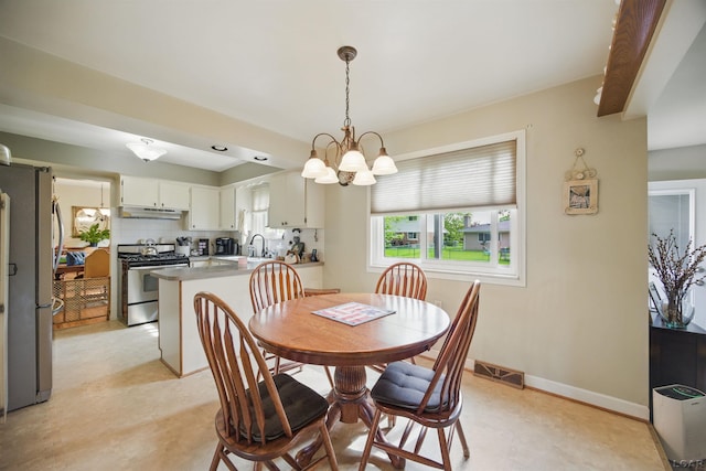 39582 Tunstall St, Clinton Township, MI 48038 - dining area featuring a chandelier, light floors, and baseboards