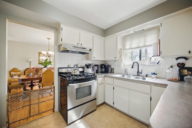 39582 Tunstall St, Clinton Township, MI 48038 - kitchen with under cabinet range hood, gas range, a sink, and decorative backsplash