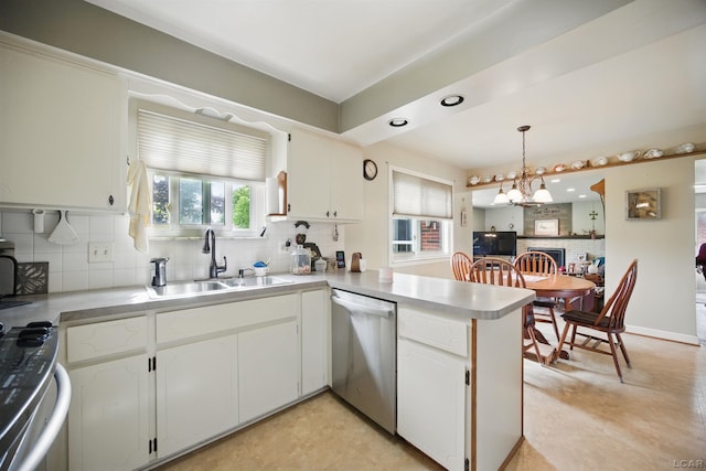39582 Tunstall St, Clinton Township, MI 48038 - kitchen with stainless steel appliances, a sink, a peninsula, tasteful backsplash, and a chandelier