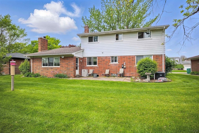 39582 Tunstall St, Clinton Township, MI 48038 - rear view of house featuring a patio, brick siding, a chimney, and a lawn