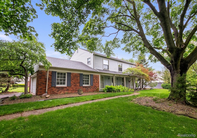 4603 Hedgewood, Bloomfield Hills, MI 48301 - traditional-style home with a garage, brick siding, and a front yard