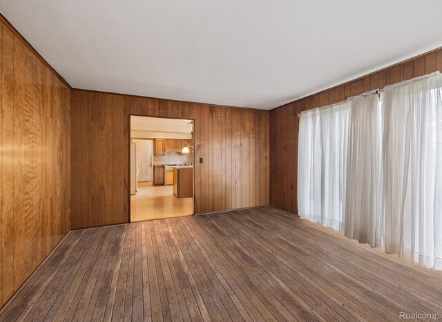 4603 Hedgewood, Bloomfield Hills, MI 48301 - empty room with wood-type flooring, wooden walls, and healthy amount of natural light