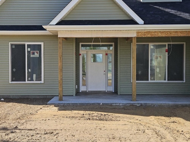 8812 Walsh Ct, Onsted, MI 49265 - view of exterior entry featuring roof with shingles