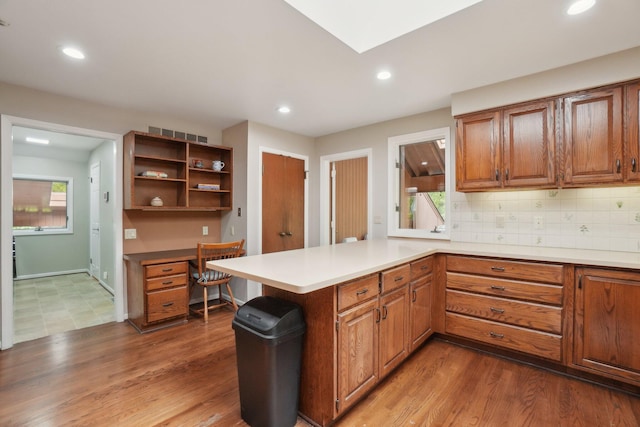 3805 Penberton Ct, Ann Arbor, MI 48105 - kitchen with a peninsula, brown cabinets, recessed lighting, tasteful backsplash, and open shelves