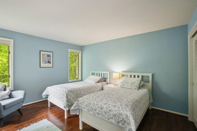 3805 Penberton Ct, Ann Arbor, MI 48105 - bedroom with dark wood-type flooring, baseboards, and a closet