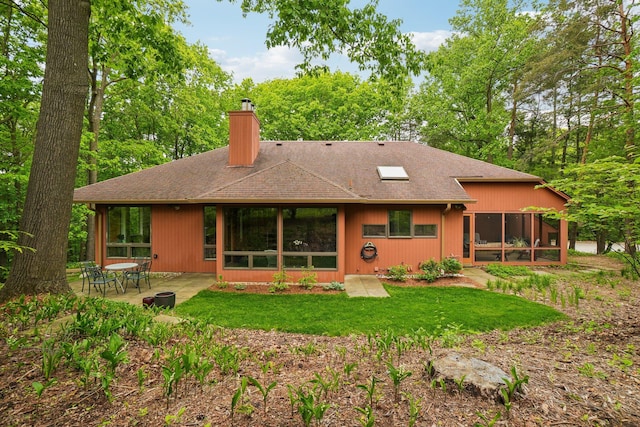 3805 Penberton Ct, Ann Arbor, MI 48105 - back of house with a chimney, a shingled roof, a patio area, and a lawn