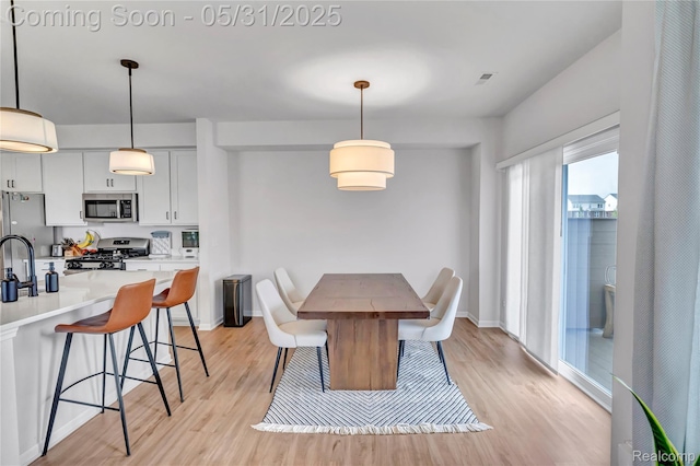 8811 Pioneer St, Washington, MI 48094 - dining area with light wood-type flooring and baseboards