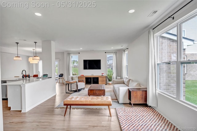 8811 Pioneer St, Washington, MI 48094 - living room featuring light wood finished floors, recessed lighting, and baseboards