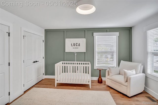 8811 Pioneer St, Washington, MI 48094 - bedroom featuring multiple windows and wood finished floors