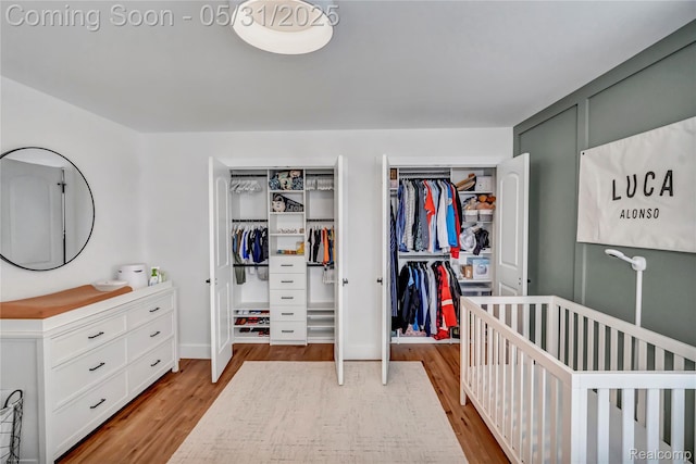 8811 Pioneer St, Washington, MI 48094 - bedroom with wood finished floors, multiple closets, and a crib