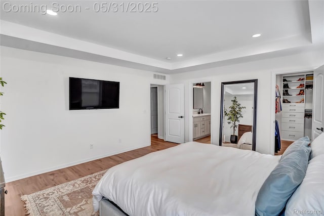 8811 Pioneer St, Washington, MI 48094 - bedroom with wood finished floors, recessed lighting, ensuite bath, a spacious closet, and a sink