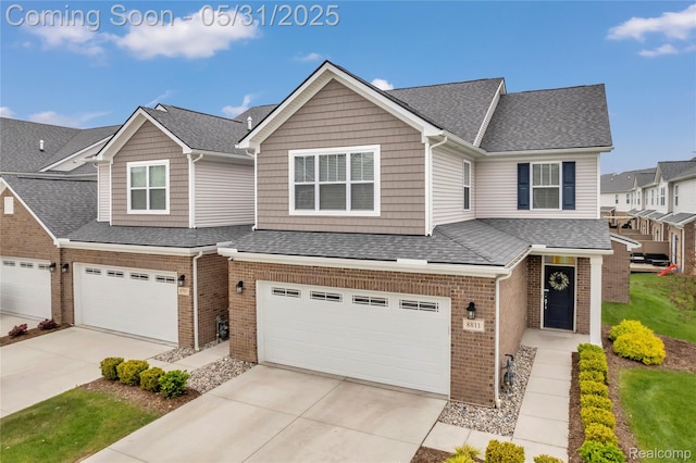8811 Pioneer St, Washington, MI 48094 - multi unit property with brick siding, an attached garage, driveway, and a shingled roof