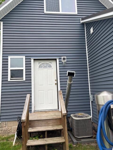 209 S Lake Ave, Fremont, MI 49412 - doorway to property with central AC unit