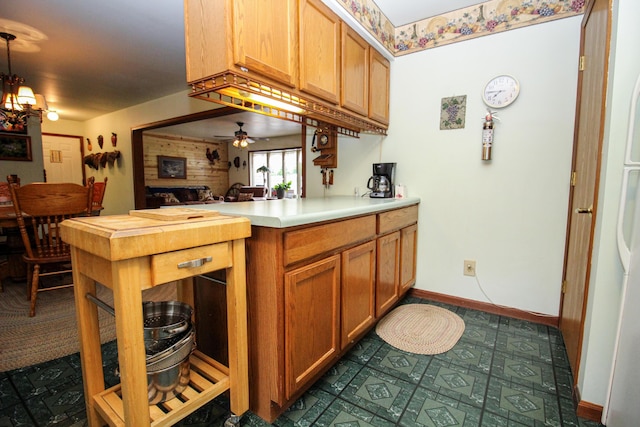 21729 Pinhook Rd, Mendon, MI 49072 - kitchen featuring light countertops, a ceiling fan, baseboards, a peninsula, and pendant lighting