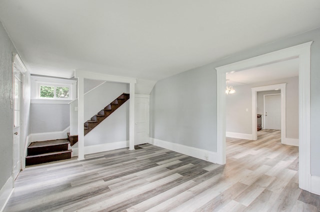 157 E Mansion St, Jackson, MI 49203 - below grade area featuring stairway, light wood-style flooring, and baseboards