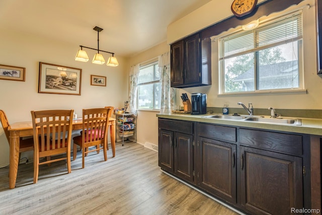 34043402 Appomattox Dr, Port Huron, MI 48060 - kitchen with a sink, light wood-type flooring, hanging light fixtures, light countertops, and baseboards