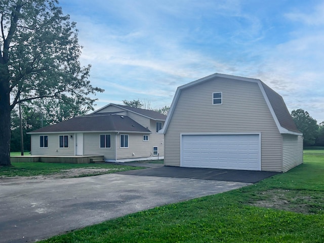 5098 N Center Rd, Flint, MI 48506 - view of property exterior featuring a gambrel roof, a lawn, an outdoor structure, and a garage