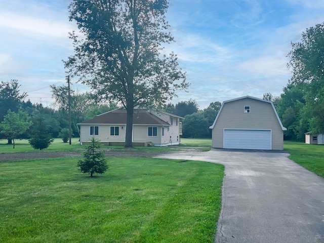 5098 N Center Rd, Flint, MI 48506 - view of front facade with an outdoor structure, a garage, and a front lawn
