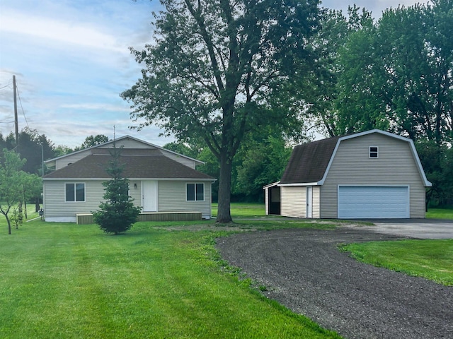 5098 N Center Rd, Flint, MI 48506 - view of front of home with an outdoor structure, a detached garage, a front yard, and a gambrel roof