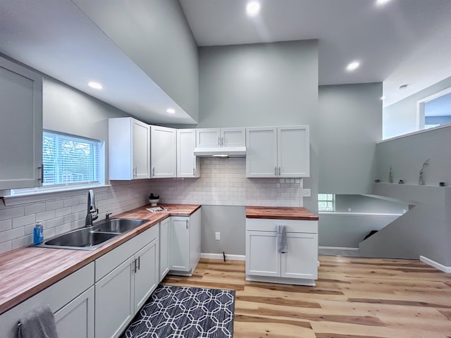 5098 N Center Rd, Flint, MI 48506 - kitchen with a sink, butcher block counters, light wood-style floors, backsplash, and recessed lighting