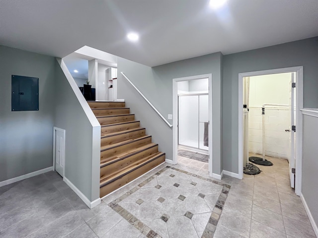 5098 N Center Rd, Flint, MI 48506 - staircase with electric panel, tile patterned flooring, recessed lighting, and baseboards