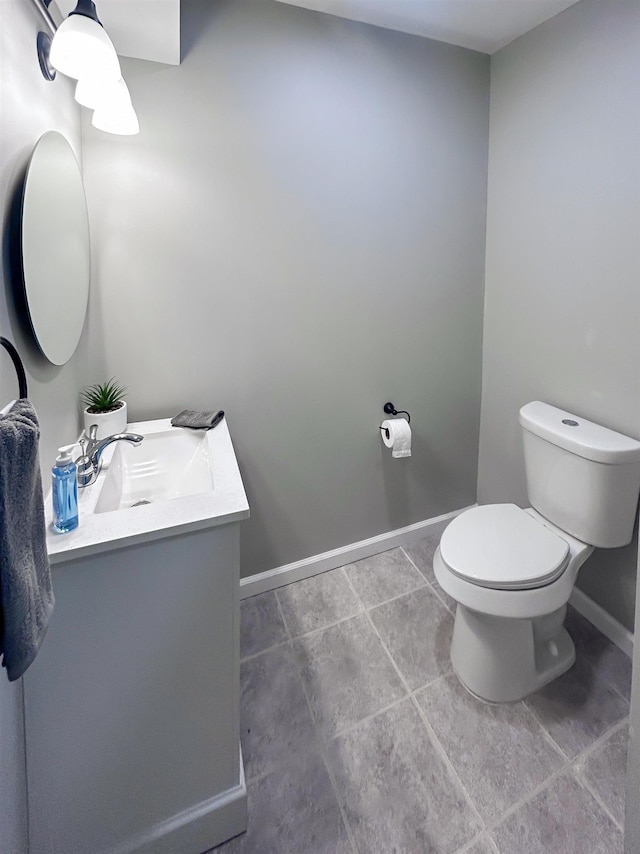 5098 N Center Rd, Flint, MI 48506 - half bathroom with vanity, baseboards, toilet, and tile patterned floors