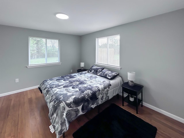 5098 N Center Rd, Flint, MI 48506 - bedroom with multiple windows, baseboards, and wood finished floors