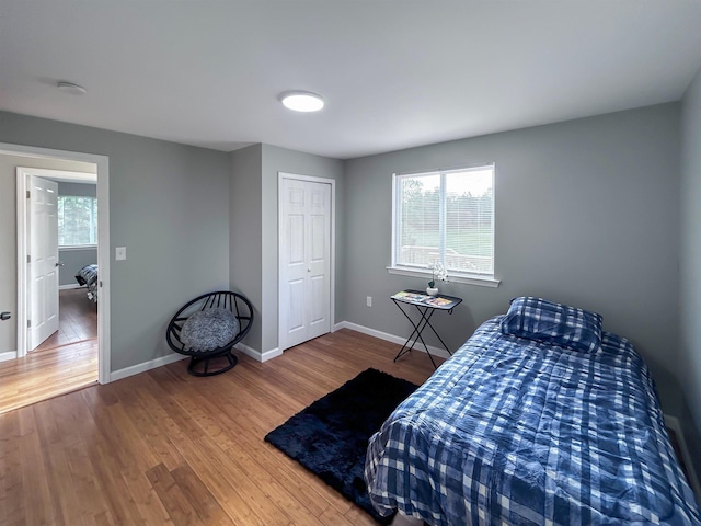 5098 N Center Rd, Flint, MI 48506 - bedroom with wood finished floors, baseboards, and a closet
