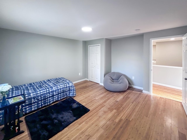 5098 N Center Rd, Flint, MI 48506 - bedroom with wood finished floors, baseboards, a closet, and recessed lighting