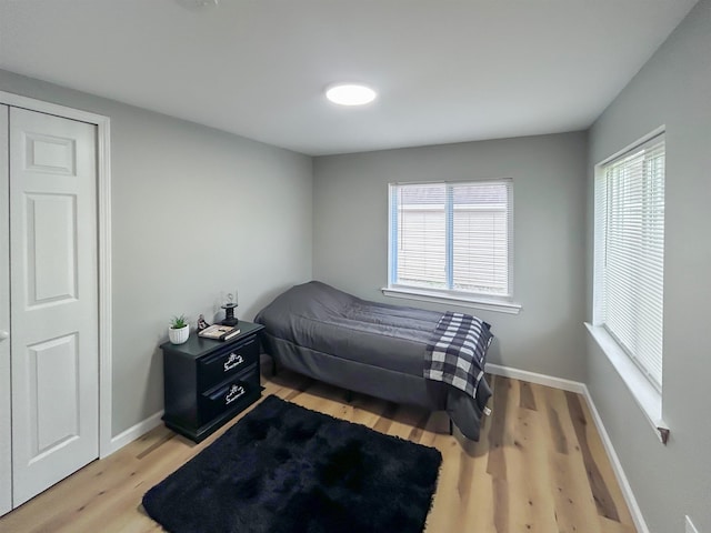 5098 N Center Rd, Flint, MI 48506 - bedroom featuring light wood-type flooring, multiple windows, and baseboards