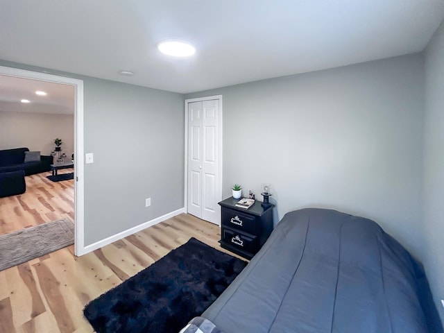 5098 N Center Rd, Flint, MI 48506 - bedroom featuring wood finished floors, a closet, and baseboards
