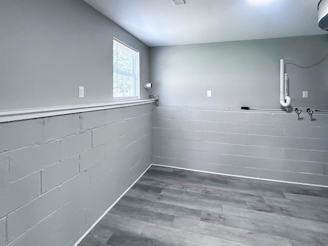 5098 N Center Rd, Flint, MI 48506 - laundry room featuring wood finished floors and concrete block wall