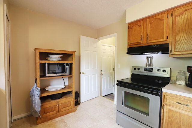 1029 N Linden Rd, Flint, MI 48532 - kitchen with appliances with stainless steel finishes, under cabinet range hood, light countertops, and baseboards