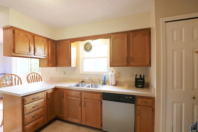 1029 N Linden Rd, Flint, MI 48532 - kitchen with dishwasher, a sink, light countertops, a textured ceiling, and brown cabinetry