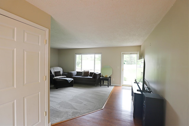 1029 N Linden Rd, Flint, MI 48532 - living room with wood finished floors, a textured ceiling, and baseboards