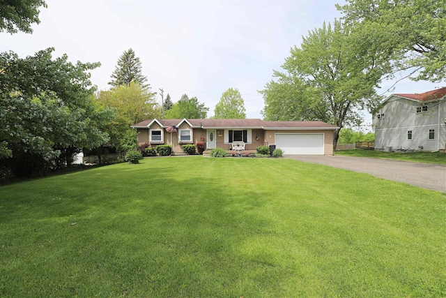 1029 N Linden Rd, Flint, MI 48532 - ranch-style home with asphalt driveway, a garage, and a front yard