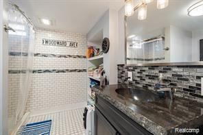 1760 Cole St, Birmingham, MI 48009 - full bath with a shower stall, vanity, and tasteful backsplash