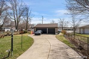 1760 Cole St, Birmingham, MI 48009 - view of front facade featuring an outdoor structure, concrete driveway, and a garage