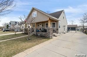 1760 Cole St, Birmingham, MI 48009 - bungalow-style home with a porch and concrete driveway
