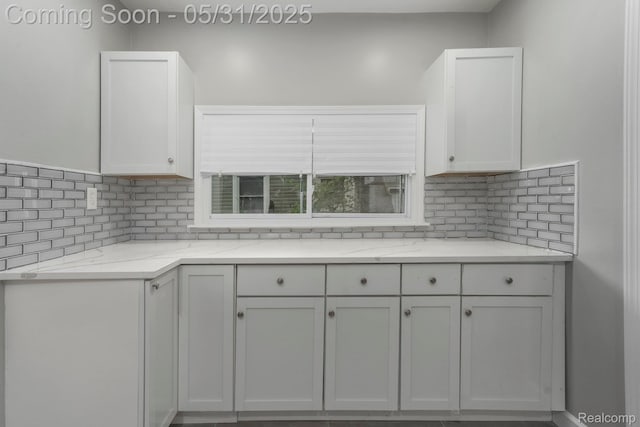 16565 Winston St, Detroit, MI 48219 - kitchen featuring tasteful backsplash, white cabinetry, and light stone countertops