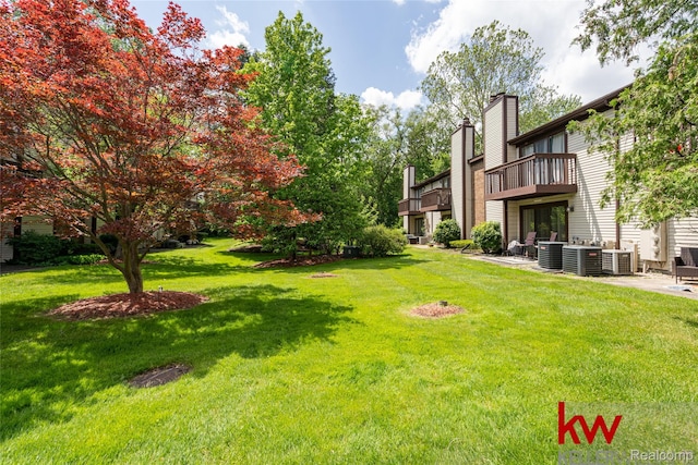 24327 Evergreen Rd, Southfield, MI 48075 - view of green lawn featuring a balcony, cooling unit, and a patio area
