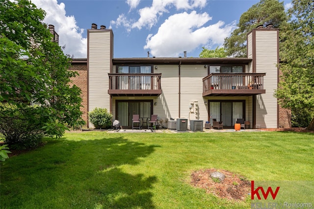 24327 Evergreen Rd, Southfield, MI 48075 - rear view of house featuring a chimney, a yard, and cooling unit