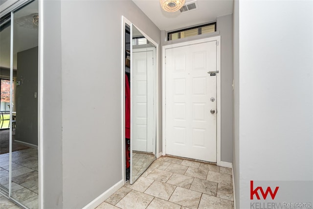 24327 Evergreen Rd, Southfield, MI 48075 - foyer featuring baseboards and light stone finish floors