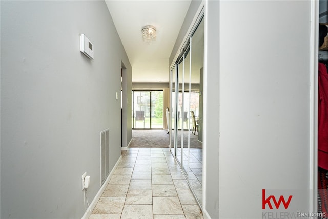24327 Evergreen Rd, Southfield, MI 48075 - hall with baseboards and light stone finish flooring