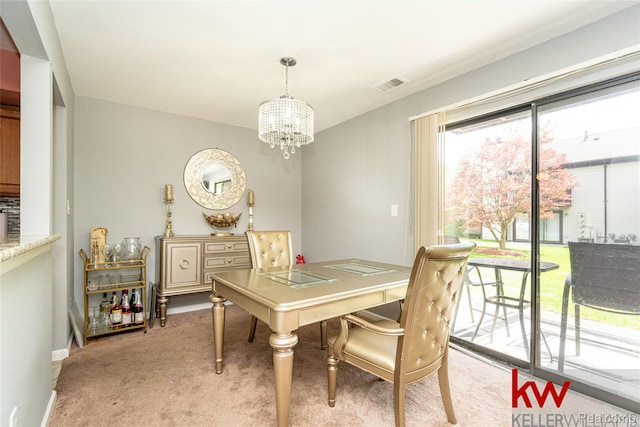 24327 Evergreen Rd, Southfield, MI 48075 - dining area featuring a chandelier, light colored carpet, and baseboards